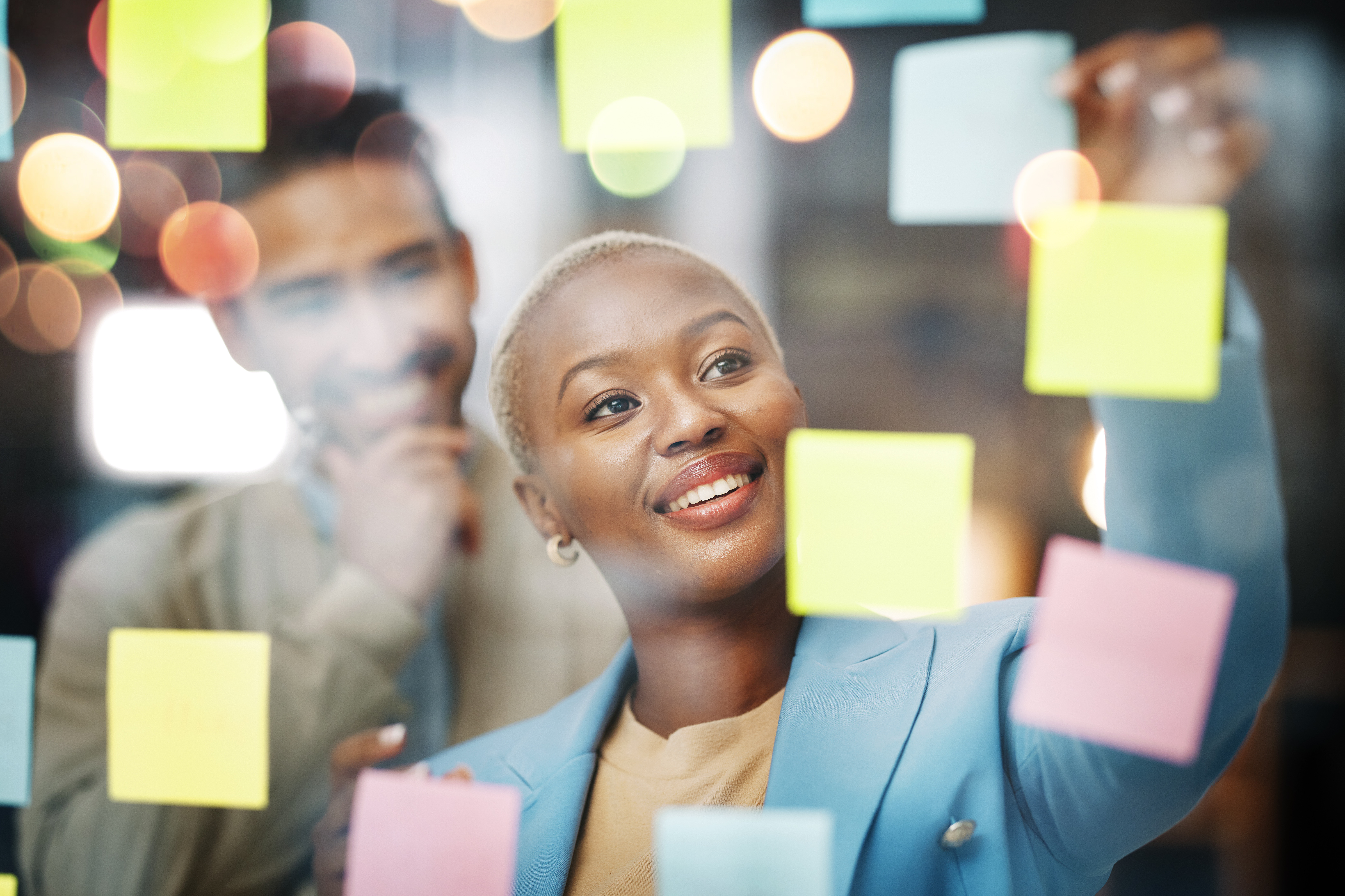 Women putting up sticky notes